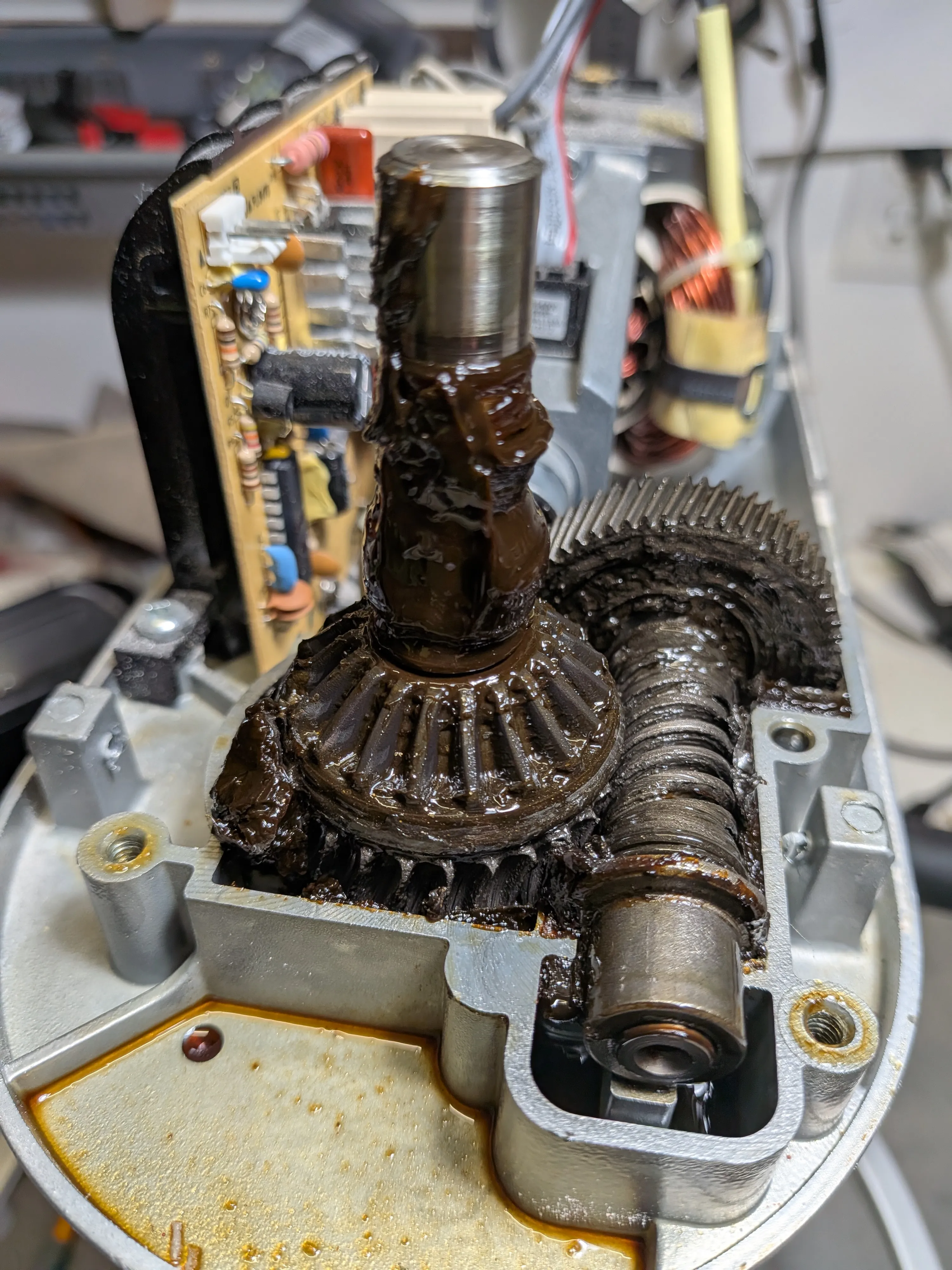 An opened bowl-lift KitchenAid mixer showing old grease and gear damage